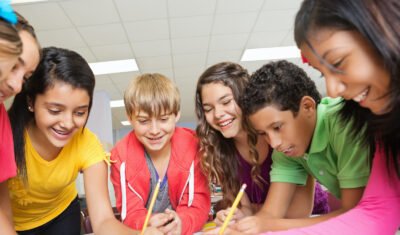 Group of middle school students working on project together